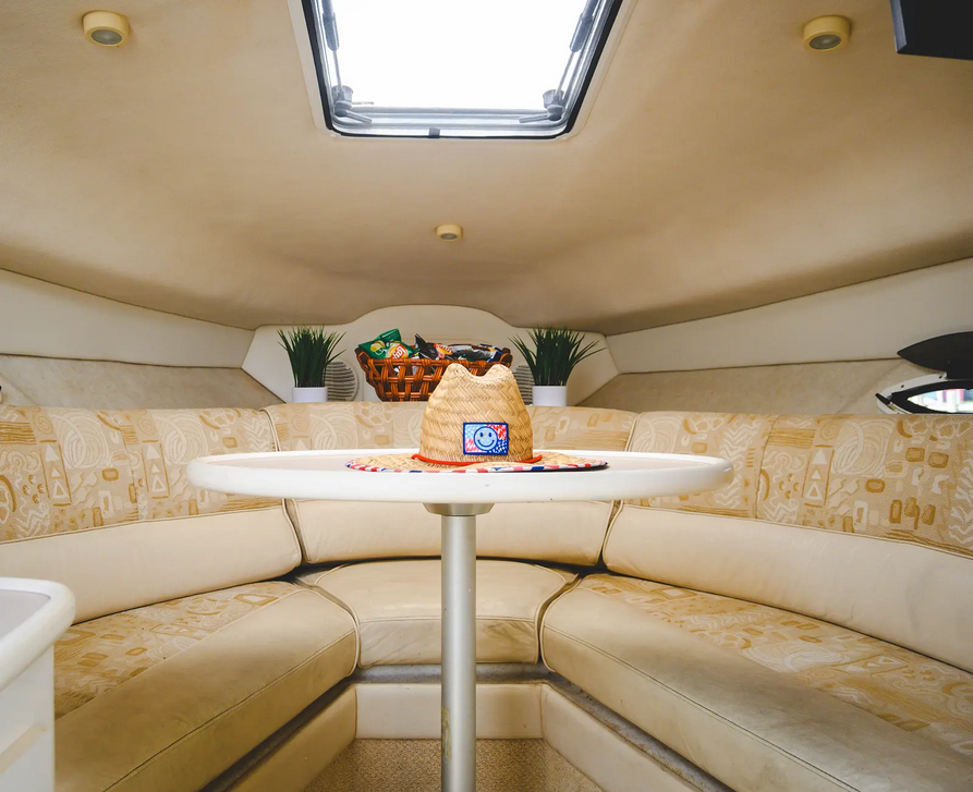 Cozy cabin interior with cream and gold furnishings on the charter boat