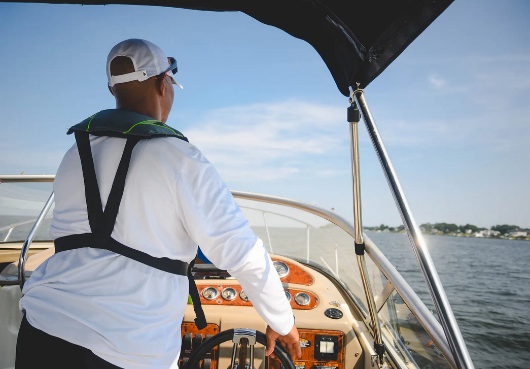 Captain at the helm guiding the boat across the Chesapeake Bay