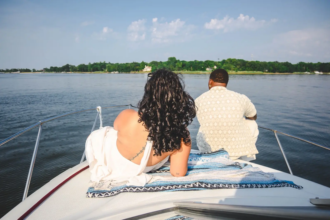 Couple relaxing on the bow watching the water